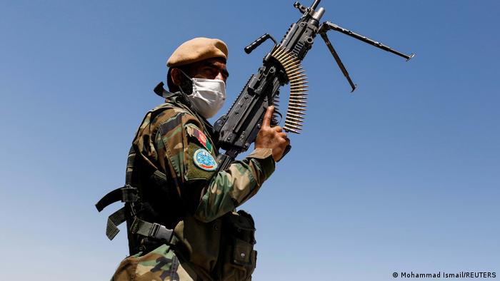 Afghan soldier holding a machine gun.