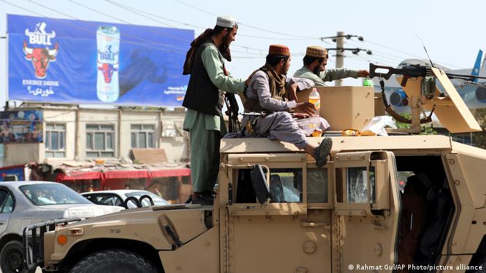 Taliban gunmen on board a Humvee.