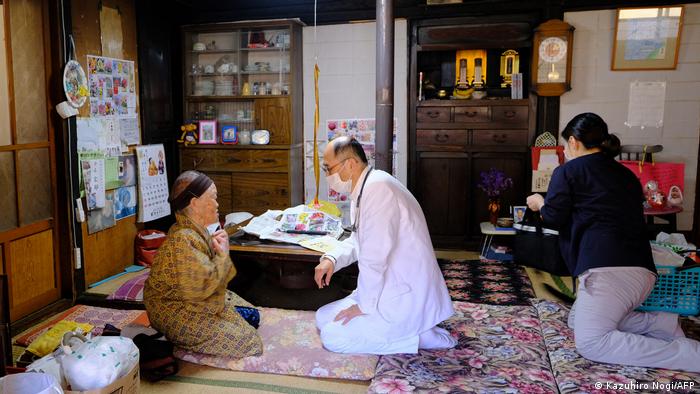 A doctor vaccinating an elderly woman in Japan