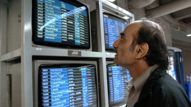 Mehran Karimi Nasseri looks at observers with flights in 2004